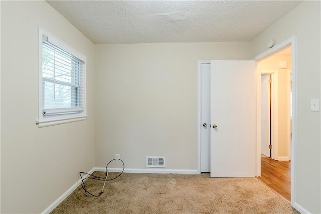 2504 Brentwood Rd, Decatur, GA 30032 - spare room featuring baseboards, visible vents, carpet, and a textured ceiling