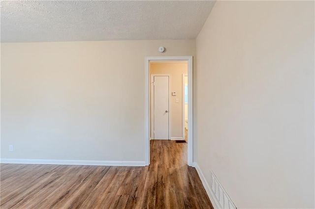 2504 Brentwood Rd, Decatur, GA 30032 - unfurnished room featuring baseboards, visible vents, wood finished floors, and a textured ceiling