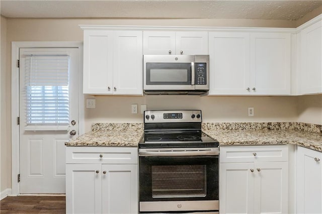 2504 Brentwood Rd, Decatur, GA 30032 - kitchen featuring white cabinetry, light stone counters, dark wood-type flooring, and stainless steel appliances