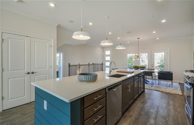 kitchen featuring sink, a kitchen island with sink, pendant lighting, and appliances with stainless steel finishes