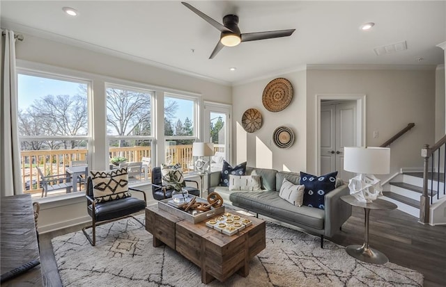 living room featuring hardwood / wood-style floors, a wealth of natural light, and ornamental molding