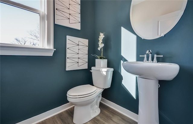 bathroom featuring wood-type flooring and toilet