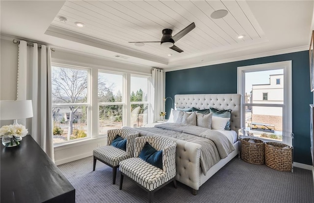 carpeted bedroom with wood ceiling, ceiling fan, a raised ceiling, and ornamental molding