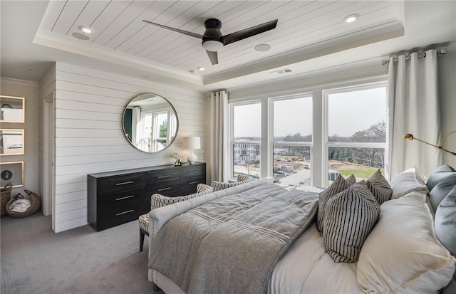 carpeted bedroom with ceiling fan, a raised ceiling, and wood ceiling