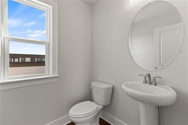 bathroom featuring toilet, vanity, parquet floors, and an enclosed shower