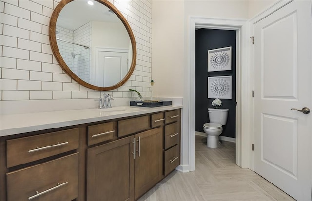 bathroom with tasteful backsplash, toilet, walk in shower, vanity, and parquet flooring