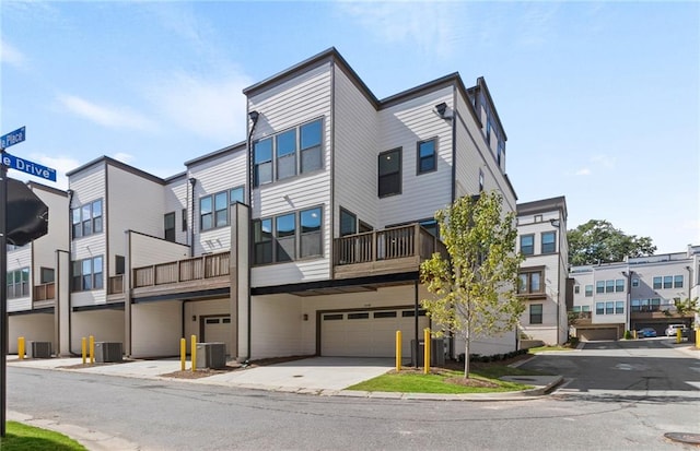 view of property featuring a garage and central AC