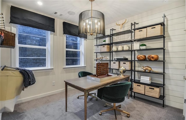 office space featuring carpet flooring and a notable chandelier