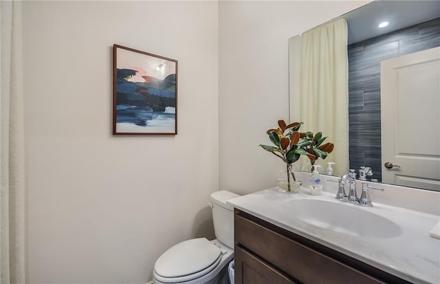 bathroom featuring toilet and vanity