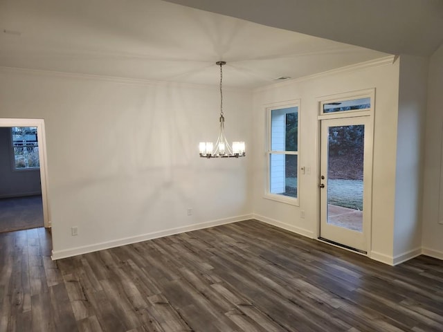 unfurnished dining area with crown molding, dark wood-type flooring, and an inviting chandelier