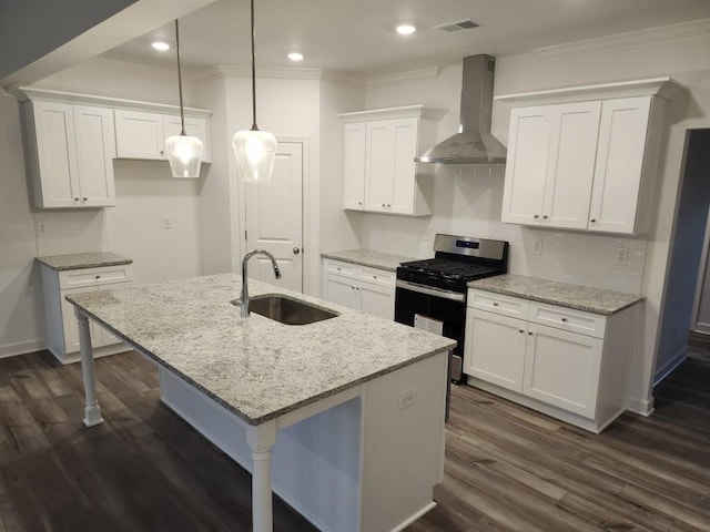 kitchen with white cabinets, sink, wall chimney exhaust hood, an island with sink, and gas stove