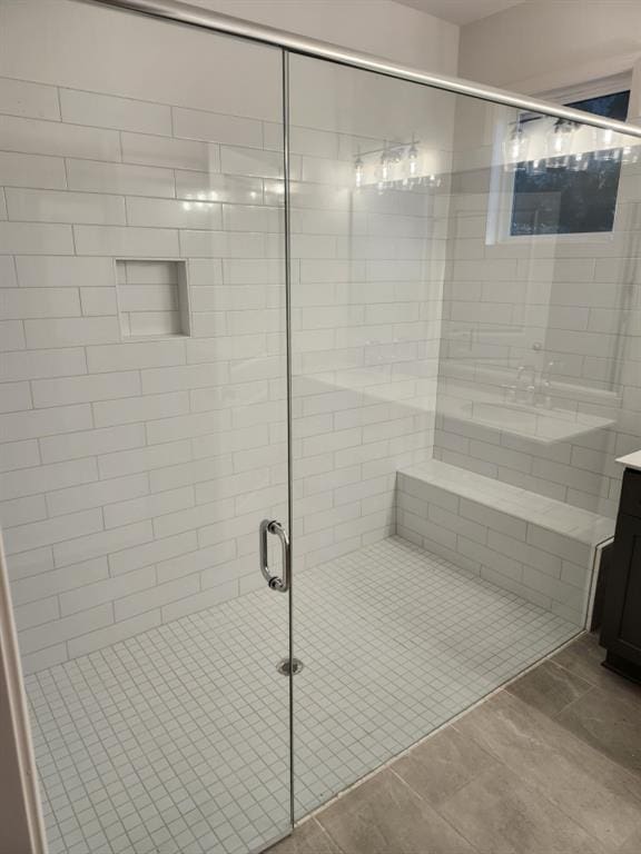 bathroom with tile patterned floors, vanity, and an enclosed shower