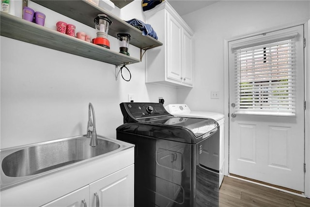 2330 Wood Creek Ct, Dacula, GA 30019 - laundry room featuring separate washer and dryer, cabinet space, and wood finished floors