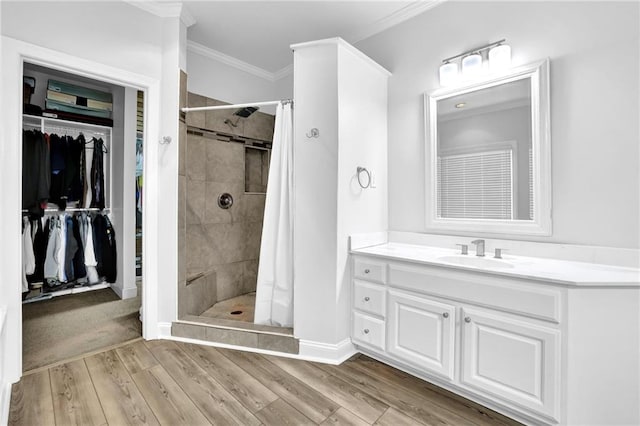 2330 Wood Creek Ct, Dacula, GA 30019 - bathroom with crown molding, a shower stall, a spacious closet, vanity, and wood finished floors