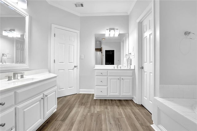 2330 Wood Creek Ct, Dacula, GA 30019 - bathroom with two vanities, wood finished floors, and crown molding