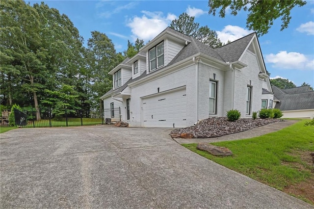2330 Wood Creek Ct, Dacula, GA 30019 - view of side of home with driveway, brick siding, an attached garage, and a shingled roof
