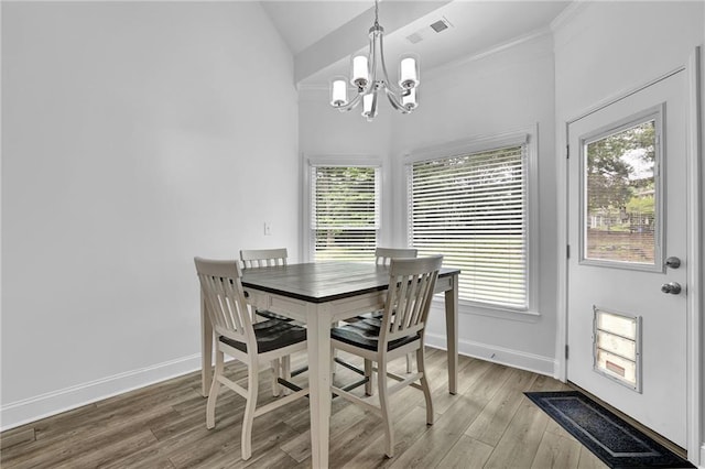 2330 Wood Creek Ct, Dacula, GA 30019 - dining space featuring a chandelier, light wood-style flooring, and vaulted ceiling
