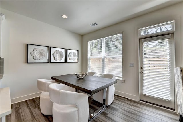 dining area with recessed lighting, wood finished floors, visible vents, and baseboards