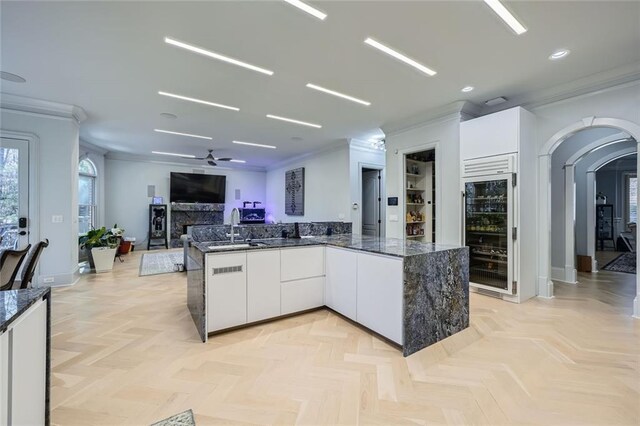 interior space with beamed ceiling, crown molding, coffered ceiling, and a notable chandelier