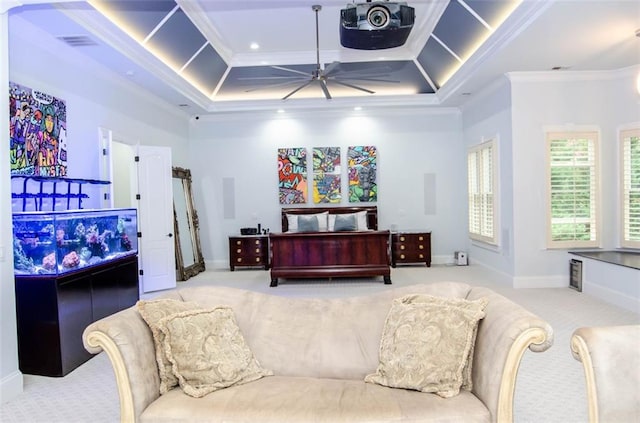 carpeted bedroom with a tray ceiling and ornamental molding