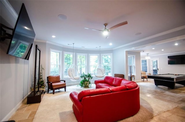 living room featuring ornamental molding, stone tile flooring, and recessed lighting