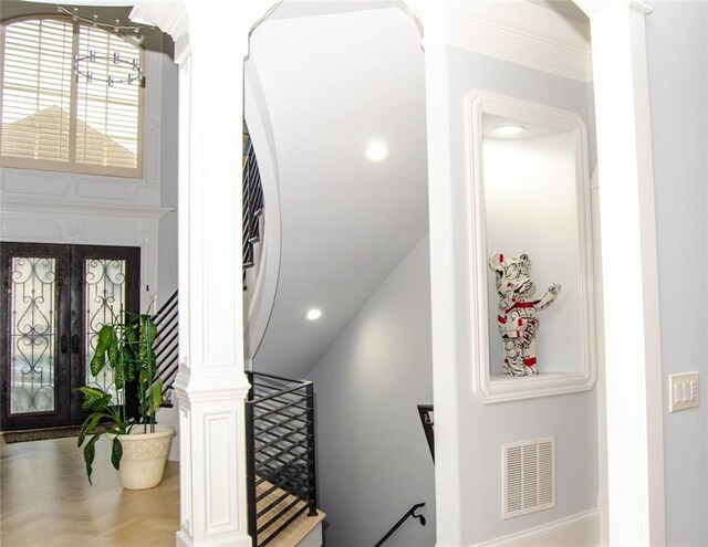 sitting room featuring plenty of natural light, an inviting chandelier, coffered ceiling, and ornamental molding