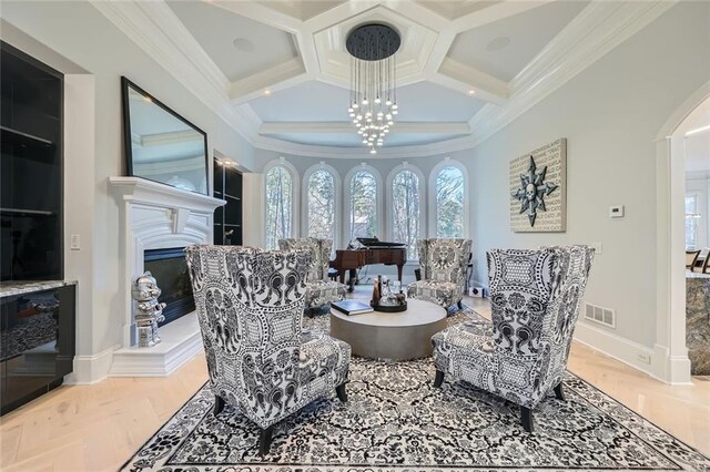 living area with a chandelier and ornamental molding