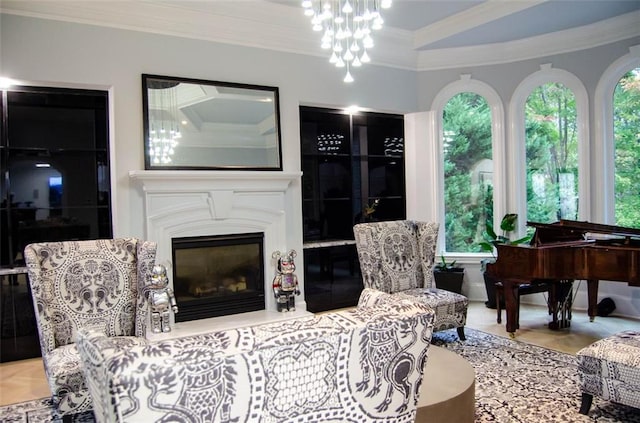 living area with ornamental molding and a glass covered fireplace