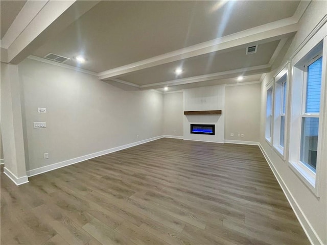 unfurnished living room with a fireplace, ornamental molding, and dark wood-type flooring