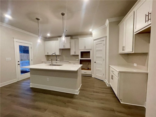 kitchen with white cabinetry, sink, an island with sink, and decorative light fixtures