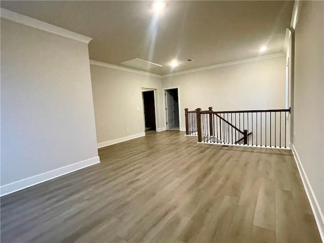 spare room featuring hardwood / wood-style flooring and crown molding