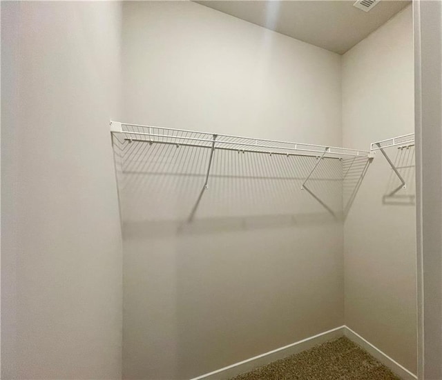 walk in closet with carpet flooring