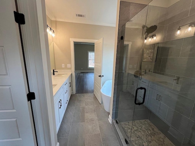 bathroom with ornamental molding, vanity, and separate shower and tub