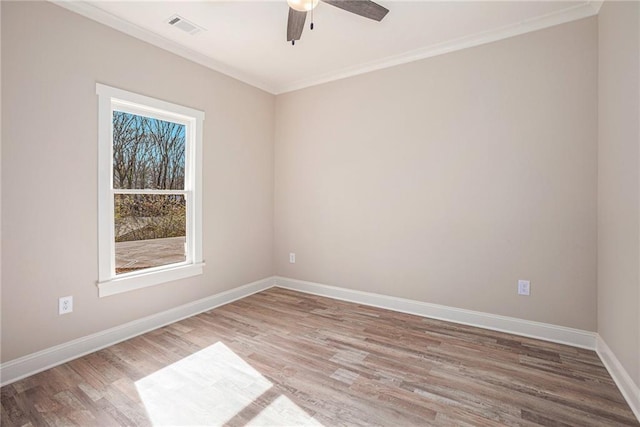 unfurnished room with ceiling fan, ornamental molding, and wood-type flooring