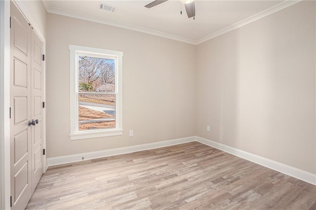 unfurnished room with ornamental molding, ceiling fan, and light wood-type flooring