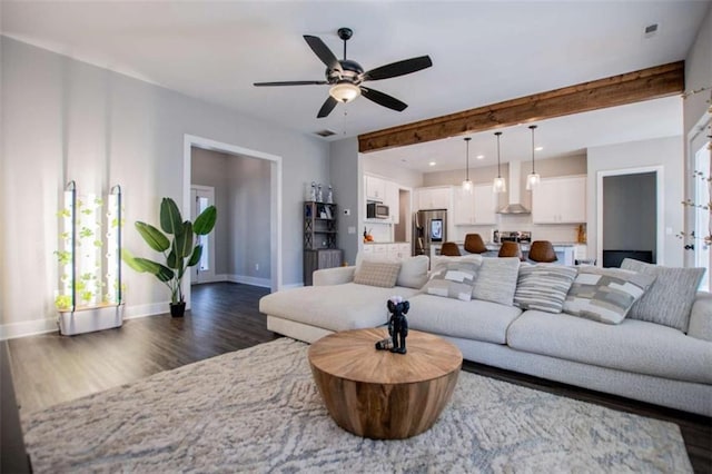 living room with beam ceiling, dark hardwood / wood-style floors, and ceiling fan