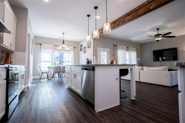 kitchen featuring range, a kitchen breakfast bar, decorative light fixtures, beam ceiling, and white cabinetry