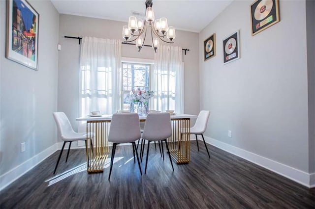 dining space featuring a notable chandelier and dark wood-type flooring