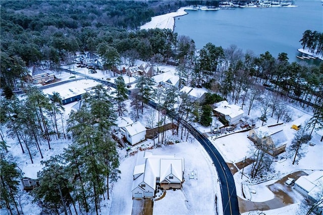 snowy aerial view featuring a water view