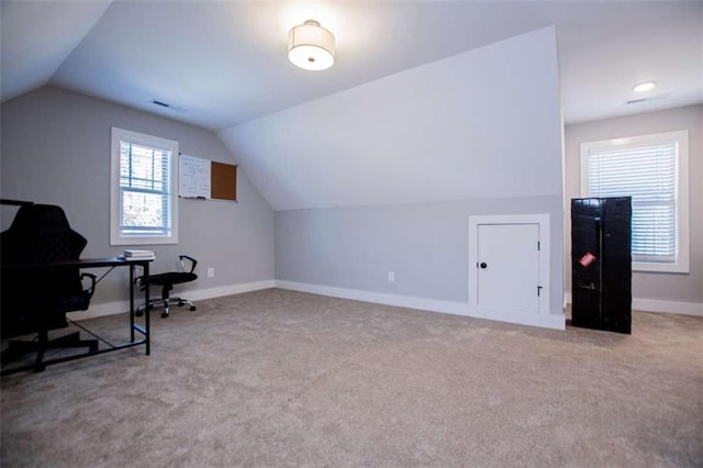 carpeted office space with lofted ceiling