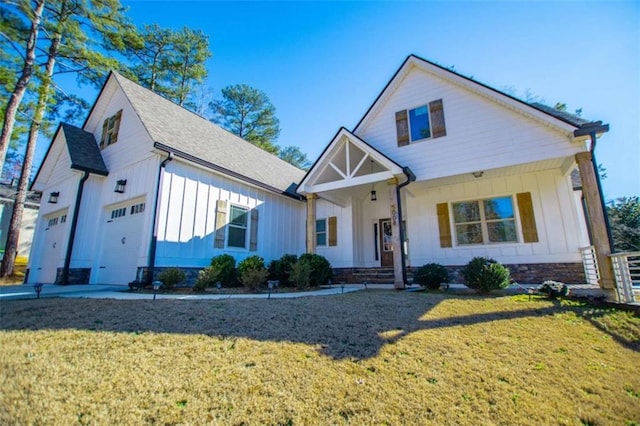 view of front of home with a front yard and a garage