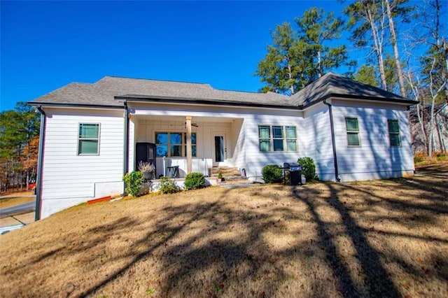 view of front of house featuring a porch and a front lawn