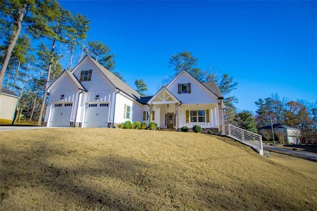 view of front of house featuring a front lawn and a garage