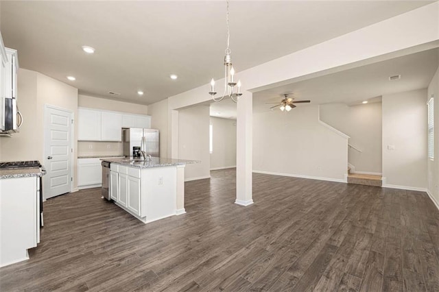 kitchen with white cabinetry, appliances with stainless steel finishes, dark hardwood / wood-style flooring, and an island with sink