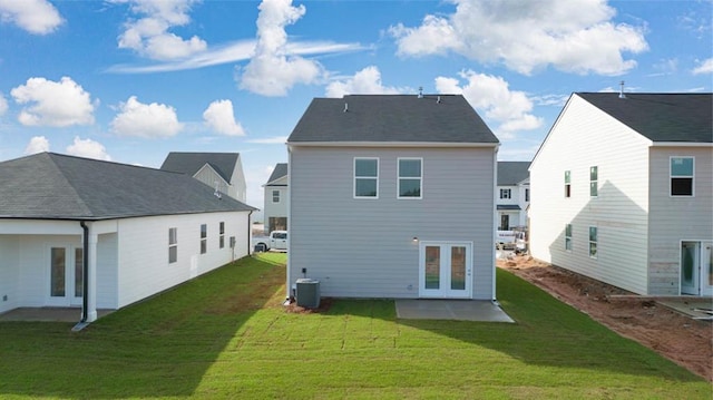 back of property with a yard, a patio area, and central air condition unit