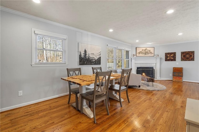 dining area featuring ornamental molding and light hardwood / wood-style floors