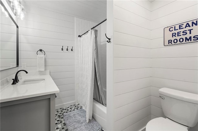 full bathroom with toilet, vanity, shower / bath combo, and wood walls