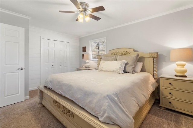 carpeted bedroom with ceiling fan, a closet, and crown molding