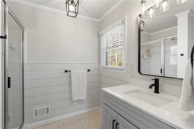 bathroom featuring tile patterned floors, a shower with door, ornamental molding, and vanity