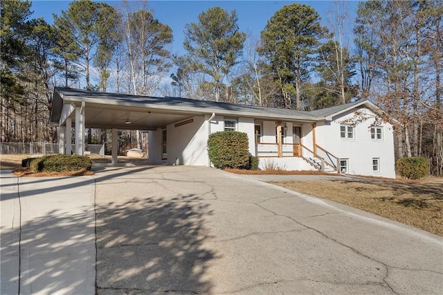 view of front of property with a porch and a carport